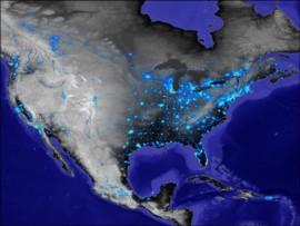 Basado en mediciones va satlite de las luces de las ciudades, esta imagen es un mapa de la densidad de poblacin urbana de Norteamrica. En rojo, amarillo y verde se representan las reas urbanas, y en azul el permetro urbano. Los datos de la luz de las ciudades estn colocados sobre datos de elevacin (negro es nivel del mar, gris claro es mayor de 10.000 pies)