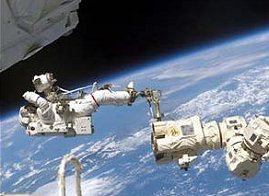 Trabajando juntos. El Astronauta Ferry Ross flota sobre la Tierra, acoplado a un extremo del  Canadarm2. <A HREF= http://spaceflight.nasa.gov/gallery/images/shuttle/sts-110/html/s110e5822.html>[ms]</A>